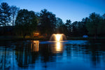 An outdoor lighting set installed around a fountain at night, highlighting the warm white glow of the LED lights.