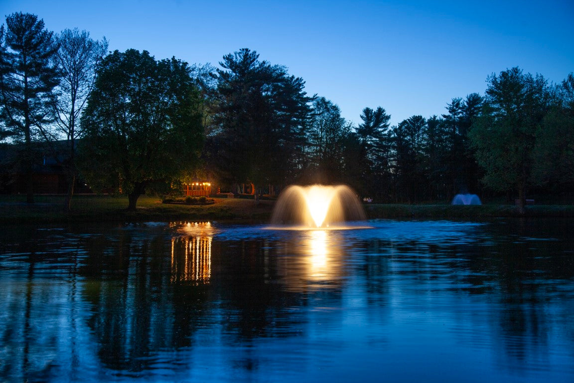 An outdoor lighting set installed around a fountain at night, highlighting the warm white glow of the LED lights.