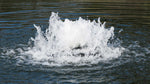 Water fountain or water feature with splashing water in a pond
